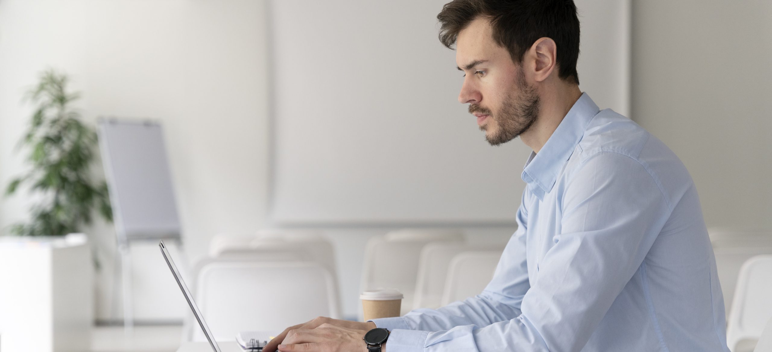 young-business-man-working-her-desk-with-laptop customer experience edukacja